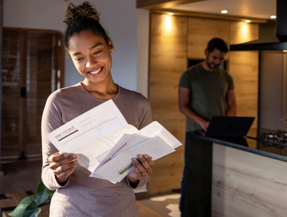 woman smiling looking at AC bill